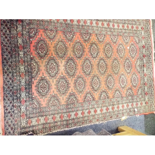 536 - A vintage red ground rug having stylised pattern measures 70