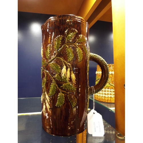 16 - A circa 1900 Rye Pottery brown glazed lemonade/water jug having applied leaf and floral decoration, ... 