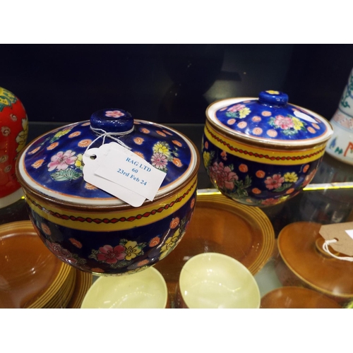 60 - A pair of Chinese lidded pots with floral decoration red seal marks to base (small rim chip to one)