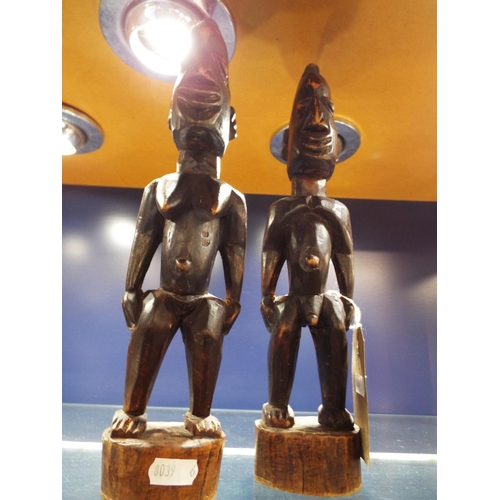 64 - A pair of carved wooden African figures