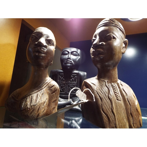 66 - Two carved wooden figures together with another