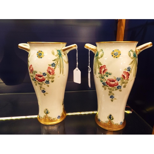 8 - A pair of McIntyre Moorcroft two handle vases with gilt banding classical swags of roses and forget-... 