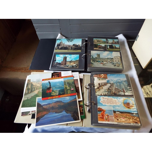 111 - Two albums of assorted postcards