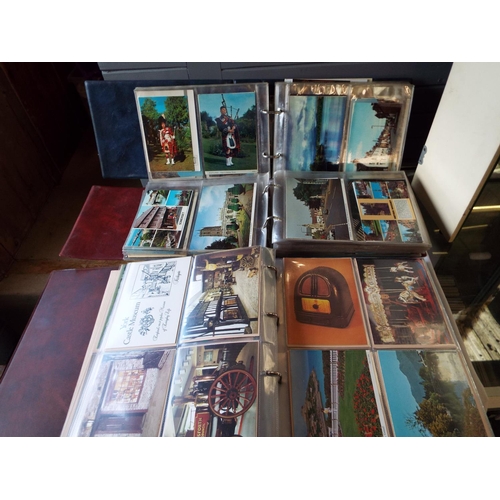 114 - Three albums of assorted postcards to include boats, architectural etc