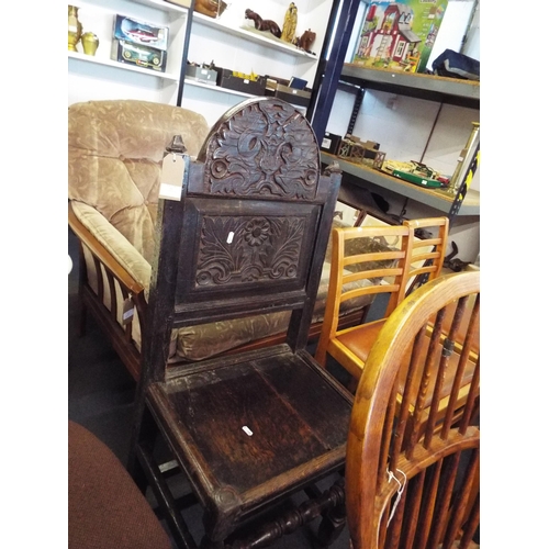 444 - A Jacobean carved back and plank seat hall chair