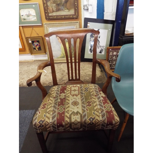 448 - A Georgian oak framed elbow chair with scrolled arms and tapestry upholstered seat