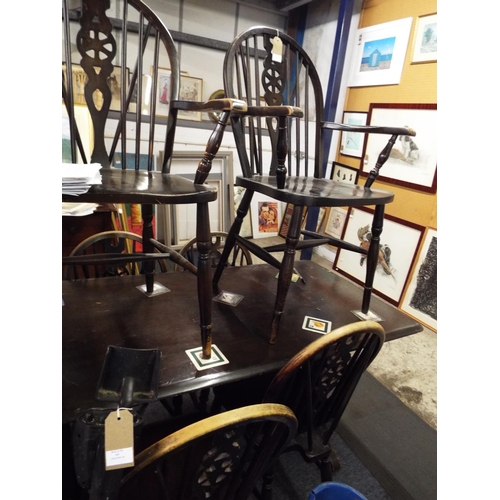 449 - A stained wood dining table, four wheel and stick back and two carver chairs