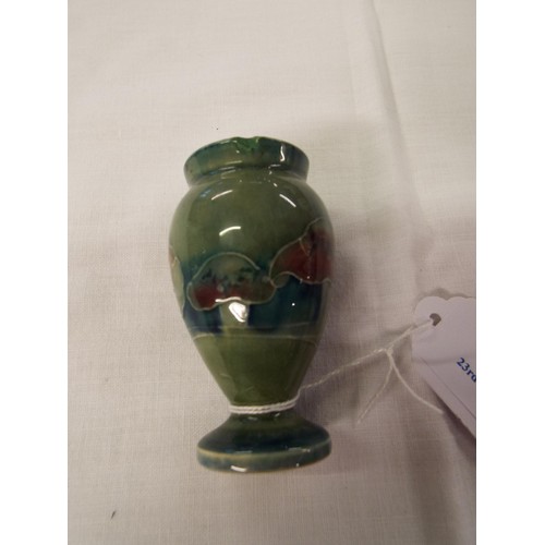 45 - A 1919 Moorcroft miniature green glazed vase signed to base (small rim chip)