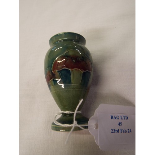 45 - A 1919 Moorcroft miniature green glazed vase signed to base (small rim chip)