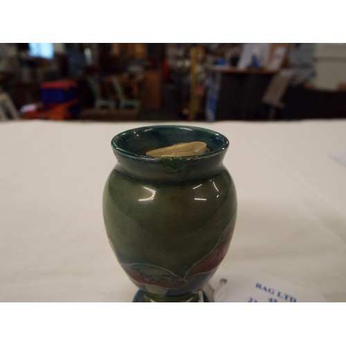 45 - A 1919 Moorcroft miniature green glazed vase signed to base (small rim chip)