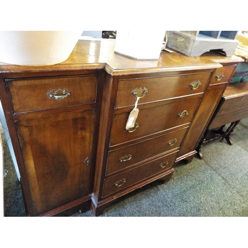 536 - A walnut crossbanded breakfront sideboard having six short drawers flanked by cupboards