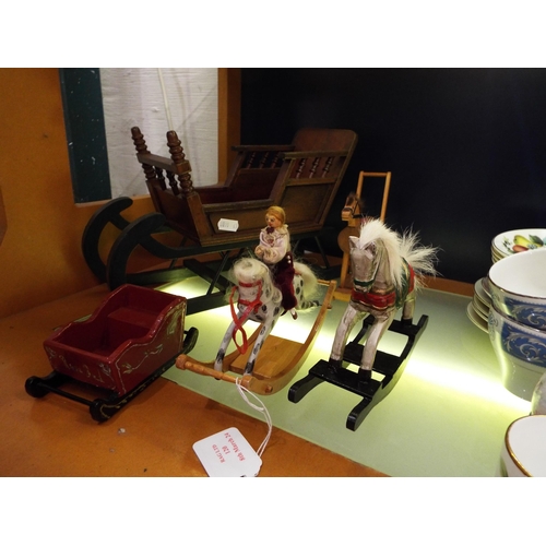 120 - A small selection of wooden dolls house furniture to include rocking horses and sleighs