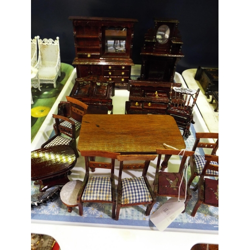 132 - A selection of wooden dolls house furniture to include table, chairs, dressers etc