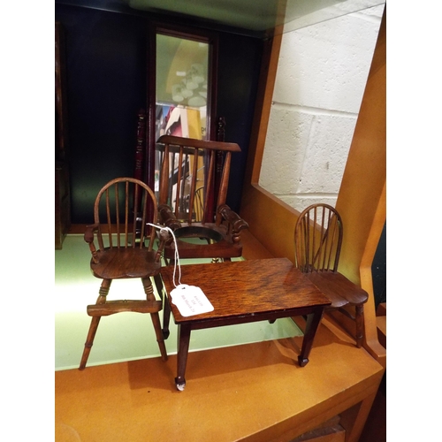 134 - A selection of large wooden dolls house furniture to include cheval mirror, table, chairs and commod... 