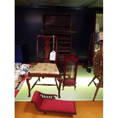 135 - A selection of large wooden dolls house furniture to include two dressers, a glass cabinet, chair an... 