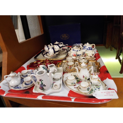 136 - A mixed selection of miniature china tea-sets to include Limoges, Newhall, Coalport examples