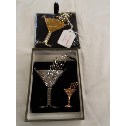 173 - Two large Butler & Wilson 'Champagne Glass' crystal fashion brooches together with a smaller one