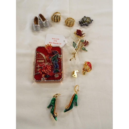 174 - A mixed selection of Butler & Wilson crystal fashion brooches, mirrored compact depicting a dragon, ... 