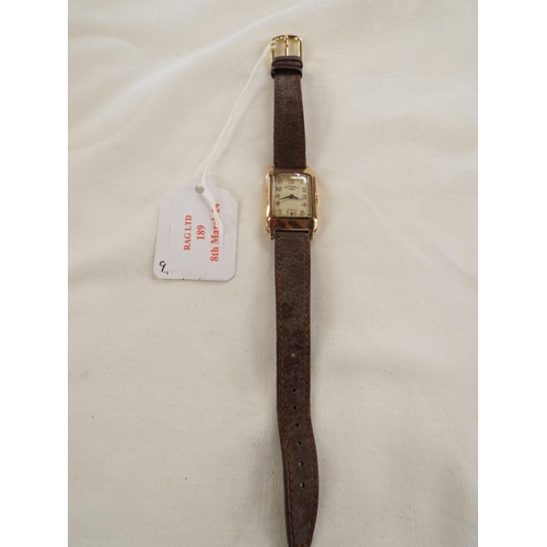 189 - A vintage 9ct gold ladies wristwatch dial having Arabic numerals and brown leather strap