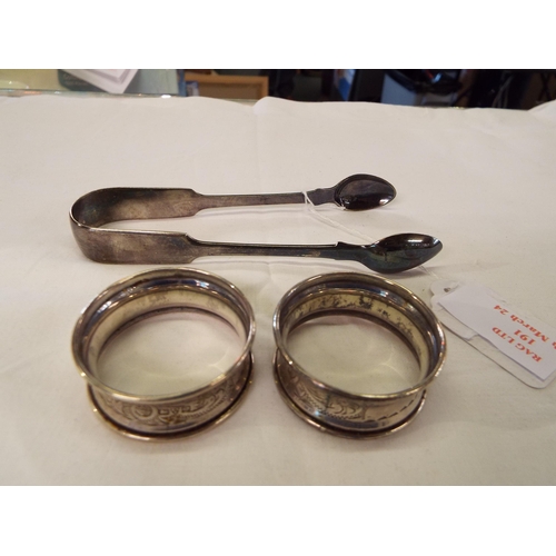 191 - Two silver napkin rings and a pair of sugar tongs