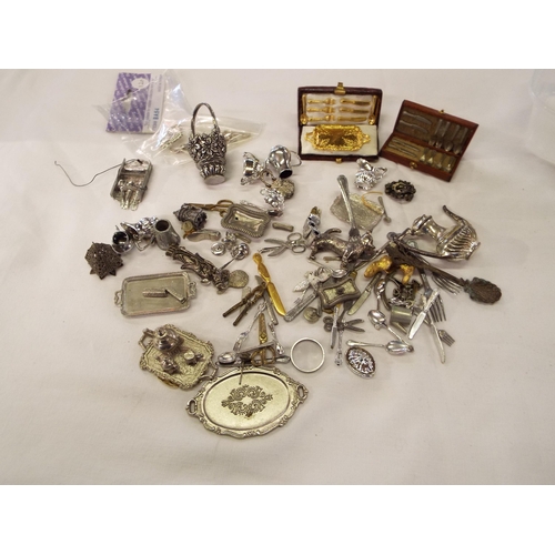 197 - A mixed selection of white metal dolls house cutlery, tea-set, dressing table set etc