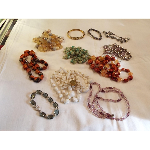 212 - A mixed selection of vintage beaded costume jewellery necklaces and a plated cuff bangle