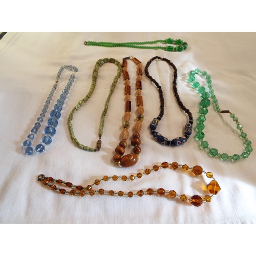 213 - A mixed selection of assorted costume jewellery necklaces to include glass examples and a necklace f... 