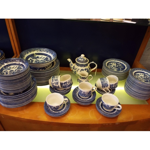 54 - A large selection of Churchill blue and white 'Willow' pattern china to include dinner plates, side ... 