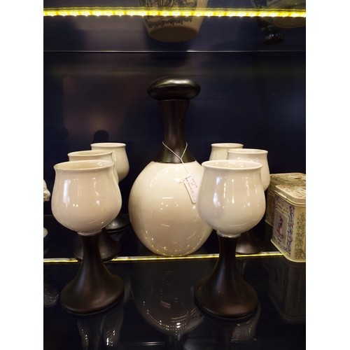 61 - A 1973 Iden Pottery flask and six goblets made for Zarcks decorated in black matt and glossy white g... 