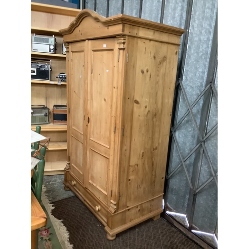 506 - A vintage pine double wardrobe with long drawer under