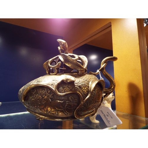 68 - An Oriental bronze incense burner, modelled as a peach and decorated with a hunting scene