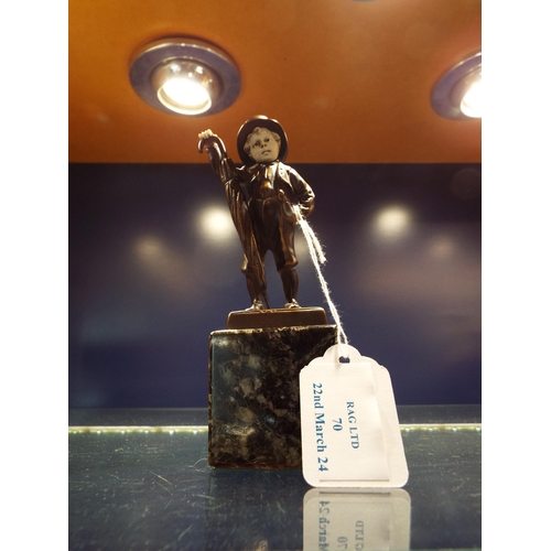 70 - A small bronze statue of a young boy holding his umbrella mounted on a marble base