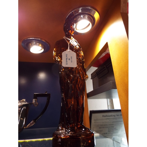 80 - An amber glass figural bottle