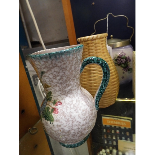 86 - A pottery jug, a West Germany vase and a floral decorated biscuit barrel