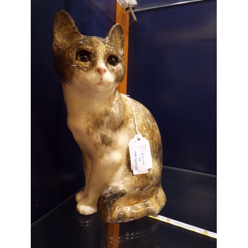 24 - A Kensington pottery figural cat designed by J Winstanley having glass eyes, singed to base 10