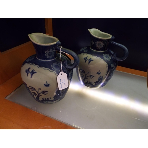 A pair of Chinese flow blue willow pattern large water jugs