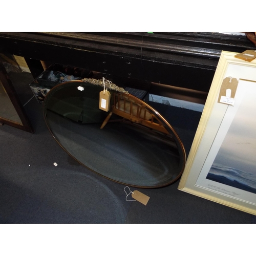 455 - A vintage oval brass framed bevel glass mirror