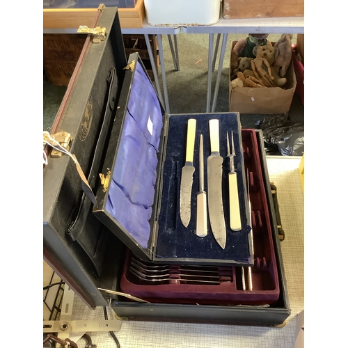 622 - A cased set of cutlery together with a boxed set of carvers