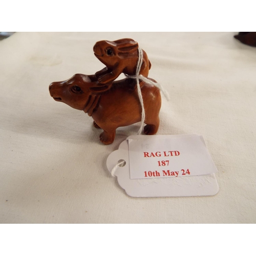 187 - A hand carved boxwood netsuke of a hippo and hare signed to base