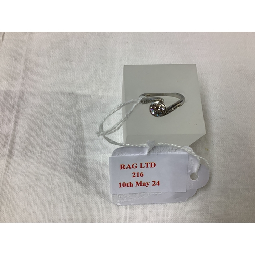 216 - A platinum cross-over ring inset with 1.02 brilliant cut diamond flanked by 1ct diamonds inset to th... 