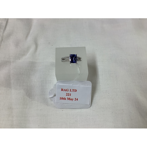 221 - A 18ct white gold ring inset with large tanzanite flanked by diamonds, size K