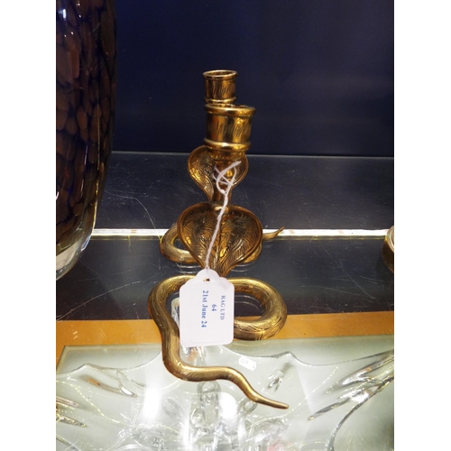 64 - A pair of brass Cobra candlestick holders