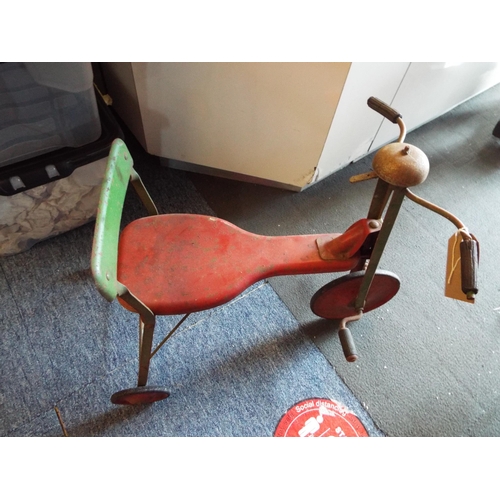 A vintage green and red Tri-ang tricycle with bell