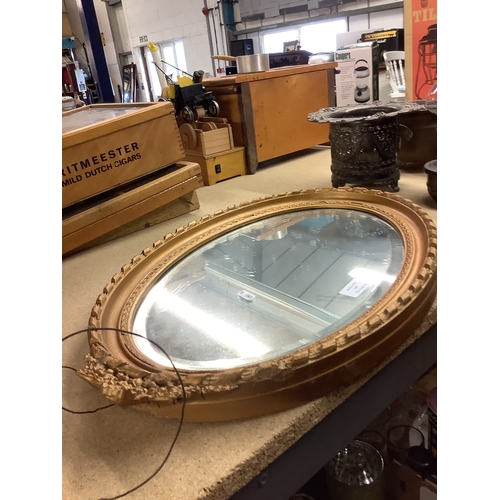 547 - An oval gilt mirror