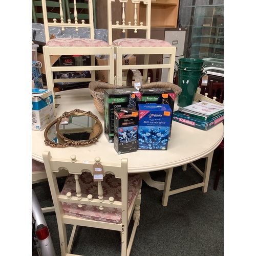 579 - A large circular cream painted dining table and six matching chairs