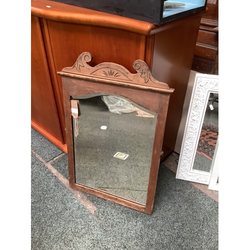 580 - An oak framed bevel glass mirror