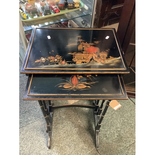 591 - A nest of two Japanese black lacquered chinoiserie decorated tables