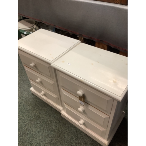 628 - A pair of three drawer white painted bedside cabinets