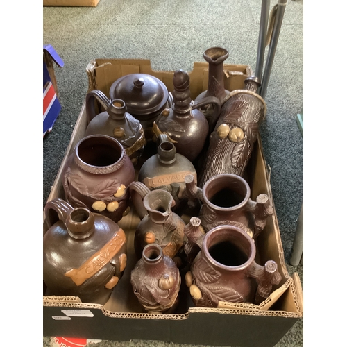 634 - A mixed selection of salt glazed Calvados bottles, vases etc