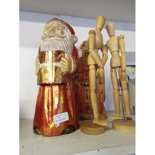 445 - A wooden figurine of Father Christmas, an Oriental man and two wooden artist mannequins